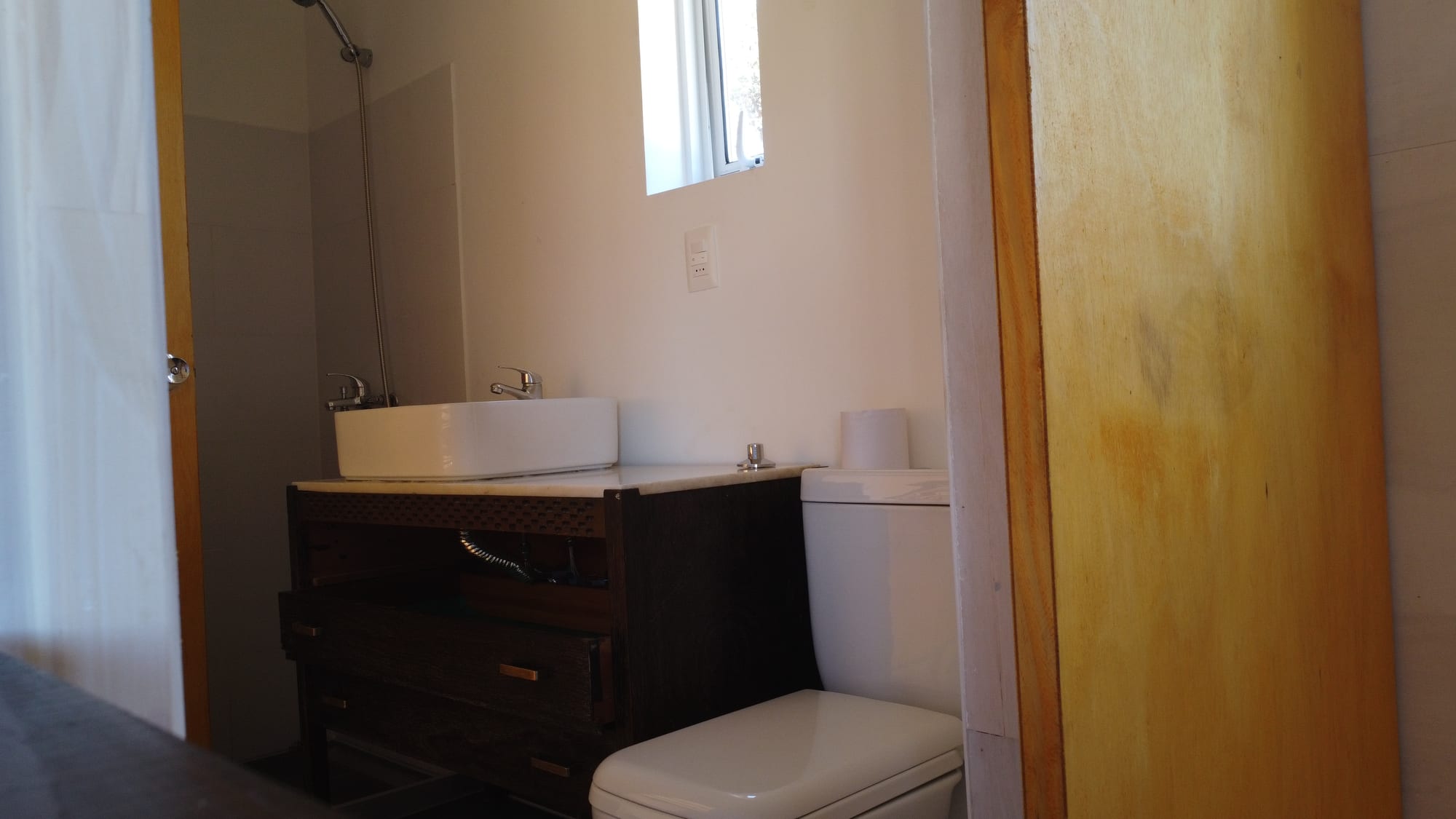 Finished bathroom, dark wood vanity